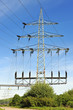 High voltage power pylon against blue sky