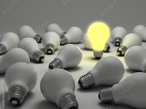 Illustration: Lit light bulb amongs unlit incandescent bulbs Lit light bulb amongs unlit incandescent bulbs