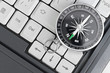 Photo: Computer keyboard and retro compass, business decision Computer keyboard and retro compass, business decision