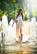 Attractive girl in  playing in  water fountain in a hot  day