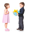 Foto: Little boy giving a gift box to her girlfriend Little boy giving a gift box to her girlfriend