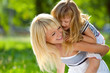 Beautiful happy girl on the back of his mother