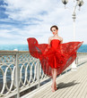 Sexy young woman in long red dress