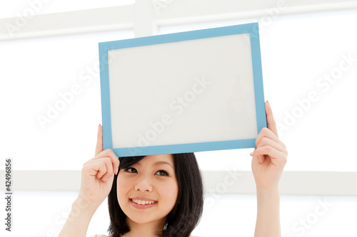 Photo: Beautiful young woman relaxing living room. Portrait of asian. Beautiful young woman relaxing living room. Portrait of asian.
