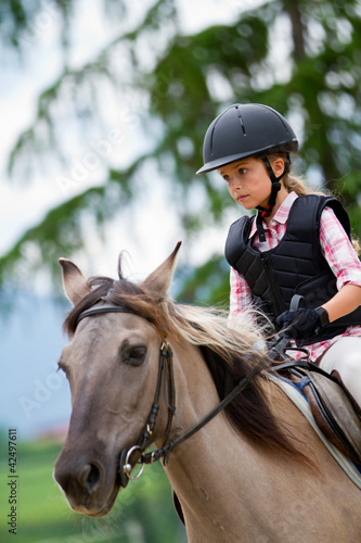 Photo: Horse riding - portrait of lovely equestrian on a horse Horse riding - portrait of lovely equestrian on a horse