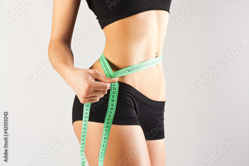 Photo: Woman measuring perfect body, healthy lifestyles concept Woman measuring perfect body, healthy lifestyles concept