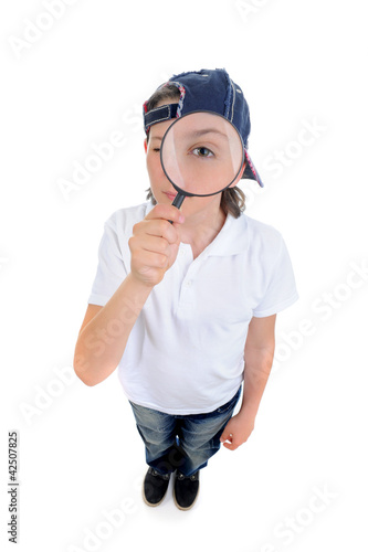 Photo: boy looking through a magnifying glass boy looking through a magnifying glass
