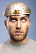 Foto: portrait of a man with a colander on his head portrait of a man with a colander on his head