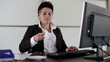 Young punk businesswoman drinking coffee in the office