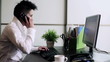 Punk businesswoman working on computer and talking on telephone