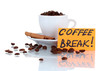 Composition of the cup with coffee beans isolated on white