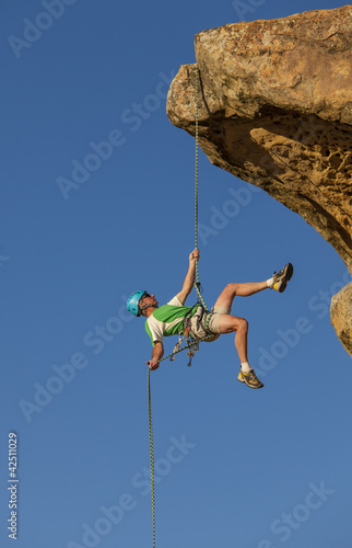 Photo: Climber rappelling from the summit. Climber rappelling from the summit.