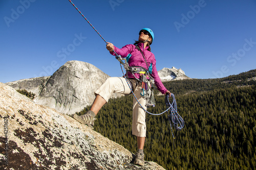 Photo: Female climber rappellling. Female climber rappellling.