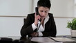 Young punk businesswoman talking on telephone in the office