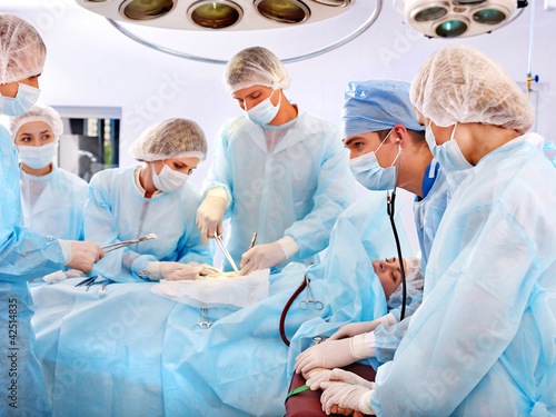 Photo: Surgeon at work in operating room. Surgeon at work in operating room.