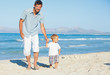 Father and son having fun on beach