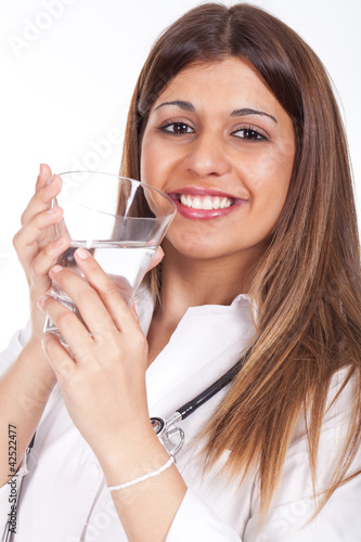 Photo: female doctor holding a glass of water female doctor holding a glass of water