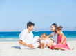 Family of four on tropical beach