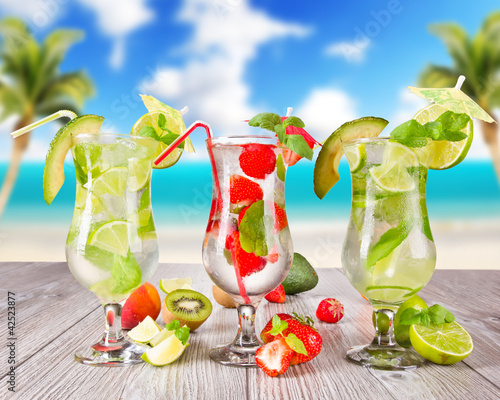 Photo: Mojitos drink with blur beach on background Mojitos drink with blur beach on background