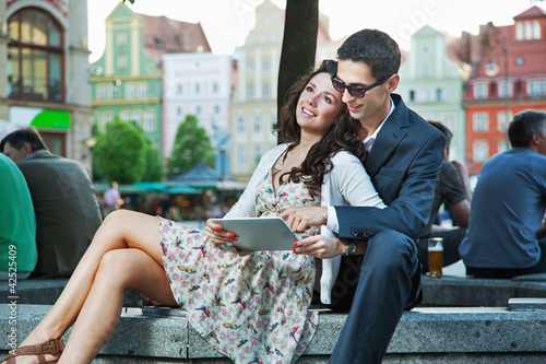 Photo: Happy couple using tablet computer Happy couple using tablet computer