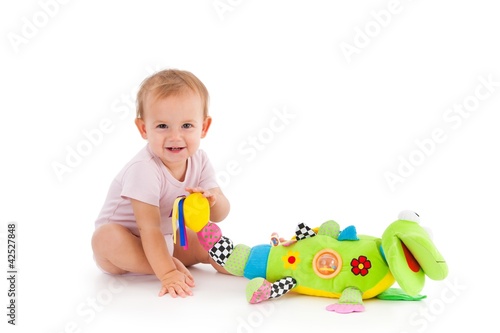 Foto: Happy toddler playing with toy Happy toddler playing with toy