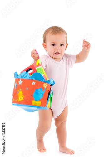 Photo: Lovely toddler holding toy in hand Lovely toddler holding toy in hand