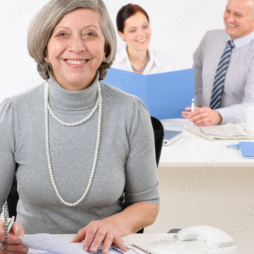 Photo: Young executive woman hold report Young executive woman hold report