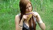 redhead girl flute player outdoors in spring meadow