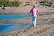 Happy mature man walking on the beach