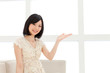 Beautiful young woman relaxing living room. Portrait of asian.