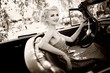 Photo: Smiling retro woman in convertible Smiling retro woman in convertible