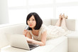 Beautiful young woman using a laptop computer. Portrait of asian