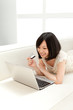 Beautiful young woman using a laptop computer. Portrait of asian