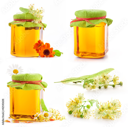 Photo: Collection of Honey in glass jar with flowers isolated on white Collection of Honey in glass jar with flowers isolated on white