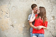 Photo: Young couple is standing grunge wall Young couple is standing grunge wall