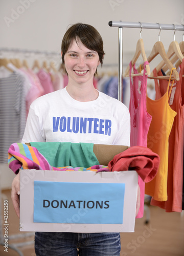 Photo: Volunteer with clothes donation box Volunteer with clothes donation box