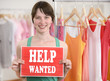 Photo: Happy owner of store with help wanted sign Happy owner of store with help wanted sign