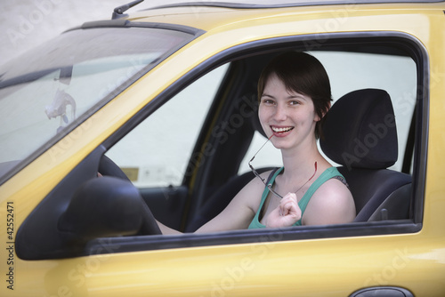 Photo: Happy woman in her car with glasses Happy woman in her car with glasses