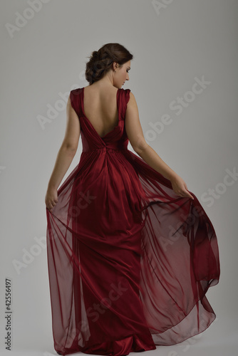 Photo: elegant woman in fashionable dress posing in the studio elegant woman in fashionable dress posing in the studio