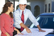 Foto: Woman & Man In Hard Hat on Construction Site Woman & Man In Hard Hat on Construction Site