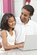 Asian Indian Father & Daughter Using Laptop Computer at Home