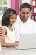 Asian Indian Father & Daughter Using Laptop Computer at Home