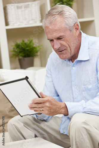 Photo: Senior Man Using Tablet Computer at Home Senior Man Using Tablet Computer at Home