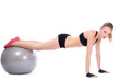 Beautiful woman doing push ups on fitness ball