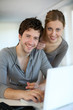 Young people studying from home with laptop computer