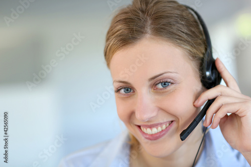 Photo: Closeup of attractive blond customer service assistant Closeup of attractive blond customer service assistant