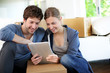 Young couple using tablet to find transport company