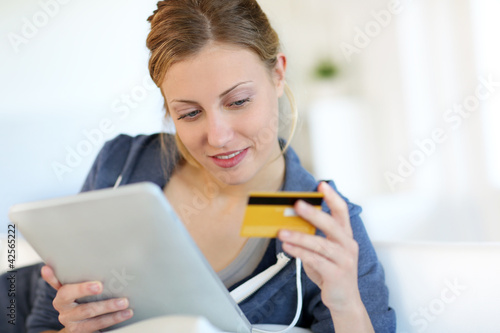 Photo: Closeup of beautiful blond girl doing online shopping Closeup of beautiful blond girl doing online shopping