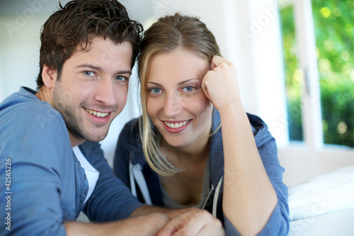 Photo: Closeup of cheerful young couple wearing blue Closeup of cheerful young couple wearing blue