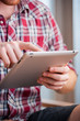 Closeup shot of male hands using a tablet